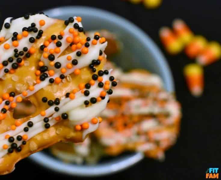 easy yogurt covered pretzels are perfect for Halloween party food! They are so easy, yummy, and a great healthy snack! My favorite guilt free Halloween treat!