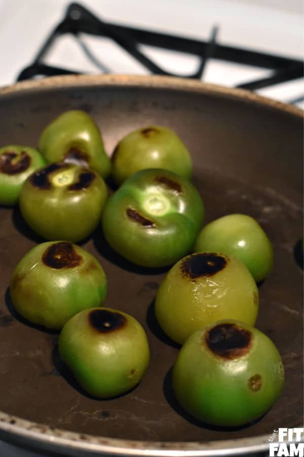 roasted tomatillos in a pan for tomatillo salsa