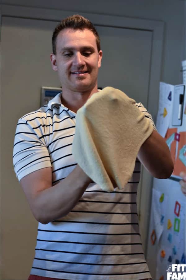 kneading pizza dough into shape