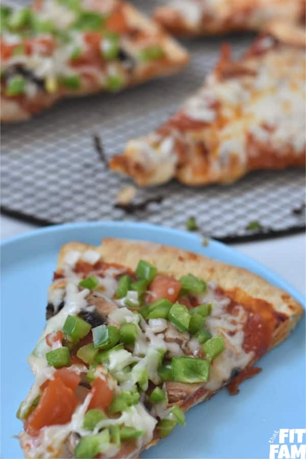 up close slice of veggie and pepperoni pizza