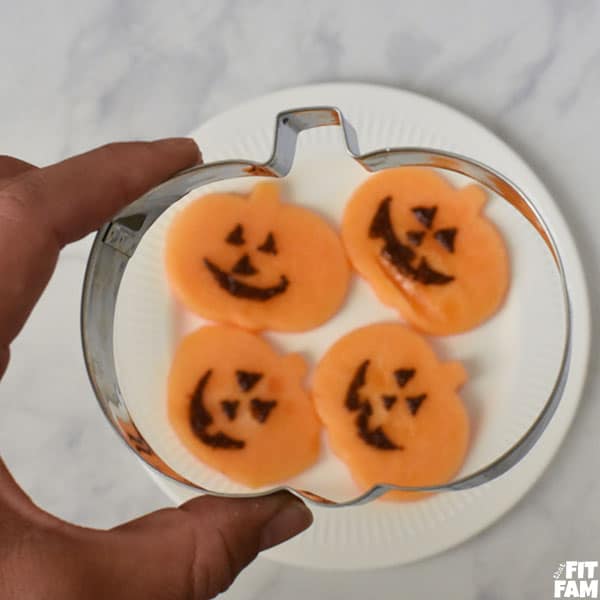Pumpkin shaped cantaloupe for Halloween party food. perfect healthy treat
