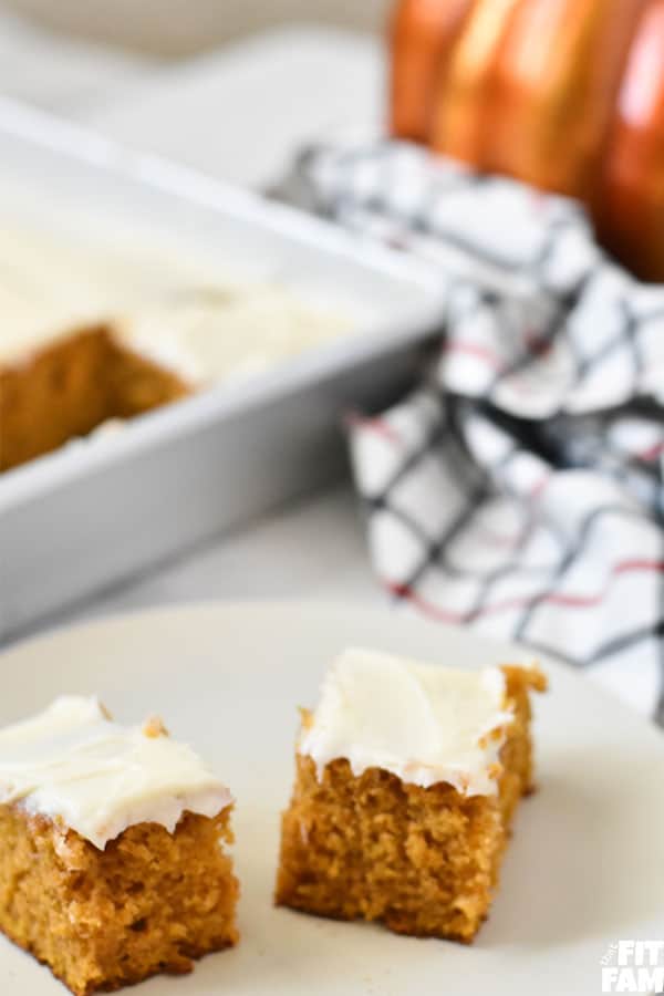 2 pumpkin bars with cream cheese frosting on a plate