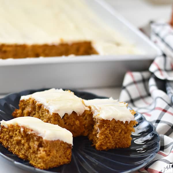 3 pumpkin bars with frosting on a plate