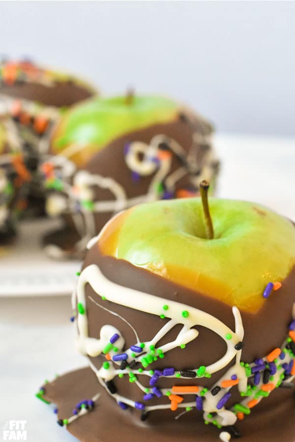 four chocolate dipped caramel apples