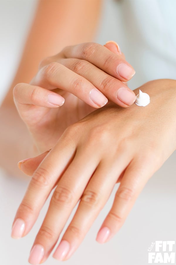 women putting lotion on hands