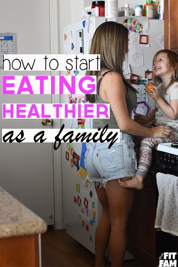 mom and daughter in kitchen eating an apple