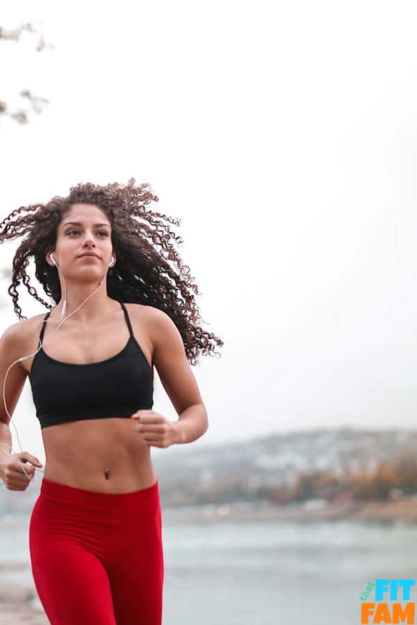 woman running near a lake