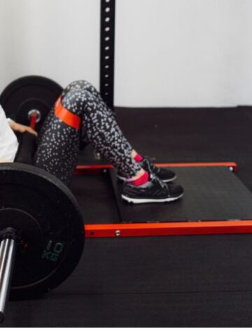 woman performing barbell hip thrusts