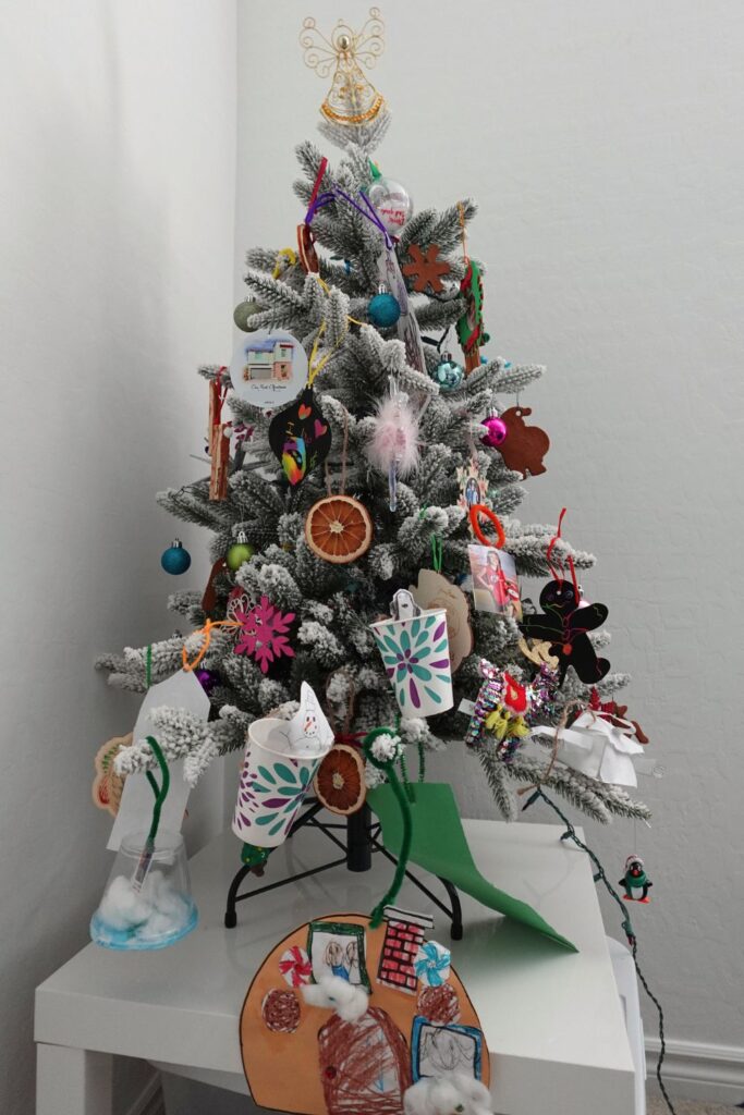 diy Christmas ornament tradition pictured is a small Christmas tree full of handmade ornaments.