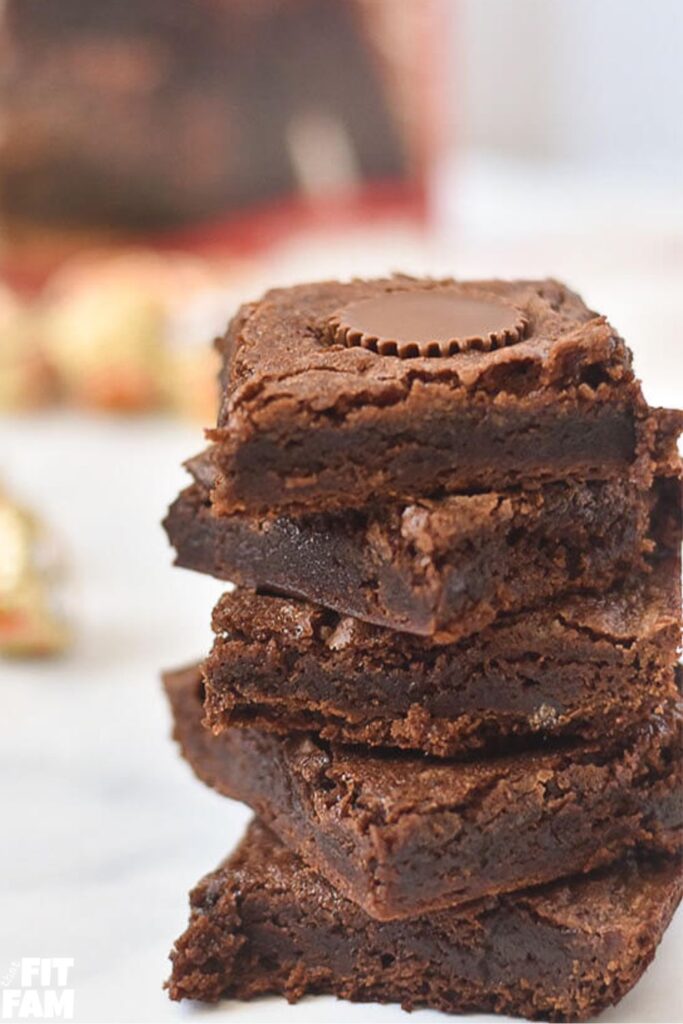 delicious fudgy brownies stuffed with reeses miniatures shown in a tall stack
