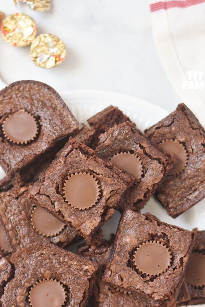 a plate of delicious fudgy brownies stuffed with reeses miniatures